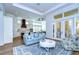 Open concept living and kitchen with light blue sofa and white cabinets at 3731 Tea Leaf Aly, Land O Lakes, FL 34638