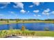 Scenic view of a lake with lush landscaping and blue skies at 3731 Tea Leaf Aly, Land O Lakes, FL 34638