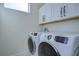 Bright laundry room with washer and dryer and upper cabinets at 3731 Tea Leaf Aly, Land O Lakes, FL 34638