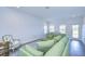 Relaxing living area with sectional sofa, wood floors and access to balcony at 3731 Tea Leaf Aly, Land O Lakes, FL 34638