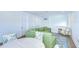 Spacious living area with green sectional sofa and access to balcony at 3731 Tea Leaf Aly, Land O Lakes, FL 34638