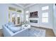 Elegant living room with fireplace, hardwood floors, and access to outdoor space at 3731 Tea Leaf Aly, Land O Lakes, FL 34638