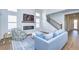 Light and airy living room with fireplace, hardwood floors, and plenty of natural light at 3731 Tea Leaf Aly, Land O Lakes, FL 34638