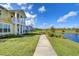 Home features a walkway alongside a canal, showcasing a peaceful waterfront view at 3731 Tea Leaf Aly, Land O Lakes, FL 34638