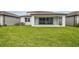 A spacious backyard with well-maintained lawn and covered patio at 4187 Feldspar Ln, Spring Hill, FL 34609