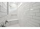 Modern bathroom featuring subway tile, a built-in shower seat, and sleek fixtures at 4187 Feldspar Ln, Spring Hill, FL 34609