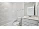 Clean, bright bathroom featuring a subway tile backsplash, sleek vanity, and modern fixtures at 4187 Feldspar Ln, Spring Hill, FL 34609