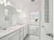 Elegant bathroom with double vanity, modern fixtures, and a window offering natural light at 4187 Feldspar Ln, Spring Hill, FL 34609