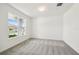 Bright bedroom with a large window and neutral carpeting at 4187 Feldspar Ln, Spring Hill, FL 34609