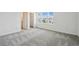 Bright bedroom with large windows offering neighborhood views and a walk-in closet at 4187 Feldspar Ln, Spring Hill, FL 34609