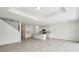 Spacious living room with recessed lighting, tile floors, and a view into the adjacent kitchen and stairway at 4187 Feldspar Ln, Spring Hill, FL 34609