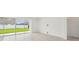 Bright and airy living room with tile floors, sliding glass doors to the backyard, and neutral decor at 4187 Feldspar Ln, Spring Hill, FL 34609