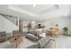 Bright, open-concept living room with modern furnishings and an adjacent kitchen area at 4187 Feldspar Ln, Spring Hill, FL 34609