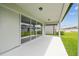 Covered patio with sliding glass doors and views of the backyard at 4187 Feldspar Ln, Spring Hill, FL 34609