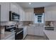 Modern kitchen with white cabinets and quartz countertops at 4199 Feldspar Ln, Spring Hill, FL 34609