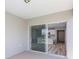 Covered patio with sliding glass doors leading to the kitchen and interior of the home at 4264 Goldfoil Rd, Spring Hill, FL 34609