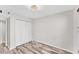 Bedroom with wood-look flooring and mirrored closet doors at 4530 Pinebrook Cir # 208, Bradenton, FL 34209
