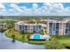 Aerial view of the community with a pool and lake at 4530 Pinebrook Cir # 208, Bradenton, FL 34209