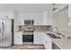 Modern kitchen with white cabinets, stainless steel appliances, and quartz countertops at 4530 Pinebrook Cir # 208, Bradenton, FL 34209