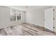 Bedroom with hardwood floors and a large window with blinds at 4530 Pinebrook Cir # 208, Bradenton, FL 34209