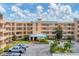 Condo building exterior with parking and landscaping at 4530 Pinebrook Cir # 208, Bradenton, FL 34209