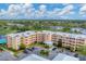 Aerial view of a condo building with parking and a pool, offering a desirable location at 4530 Pinebrook Cir # 208, Bradenton, FL 34209