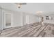 Open concept living area with wood-look floors at 4530 Pinebrook Cir # 208, Bradenton, FL 34209