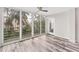 Sunroom with wood-look floors, large windows and ceiling fan at 4530 Pinebrook Cir # 208, Bradenton, FL 34209
