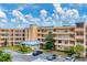 Exterior view of condo building, showing landscaping and parking at 4530 Pinebrook Cir # 208, Bradenton, FL 34209