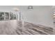 Living room with wood-look floors and access to balcony at 4530 Pinebrook Cir # 208, Bradenton, FL 34209