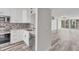 Modern kitchen with white cabinets, stainless steel appliances, and a view to the living room at 4530 Pinebrook Cir # 208, Bradenton, FL 34209