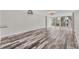 Spacious living room with wood-look floors and large windows at 4530 Pinebrook Cir # 208, Bradenton, FL 34209