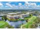 Aerial view of the community near a golf course and lake at 4530 Pinebrook Cir # 208, Bradenton, FL 34209