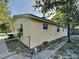 Light-yellow house with a yard and gated side entrance at 5301 82Nd N Ave, Pinellas Park, FL 33781