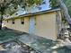 Side view of a yellow house with a white door at 5301 82Nd N Ave, Pinellas Park, FL 33781