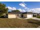 House exterior featuring a yellow facade, driveway, and landscaping at 5344 Lowell Ave, Spring Hill, FL 34609