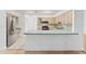 Modern kitchen featuring light wood cabinets and a breakfast bar at 5344 Lowell Ave, Spring Hill, FL 34609