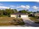 House exterior featuring a yellow facade, driveway, and landscaping at 5344 Lowell Ave, Spring Hill, FL 34609