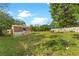 Backyard with shed and seating area under shade sail at 5344 Lowell Ave, Spring Hill, FL 34609