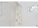 Bathroom with shower/tub combo, decorative shower curtain, and a window with bird design at 5344 Lowell Ave, Spring Hill, FL 34609