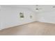 Spacious main bedroom with light wood floors and ceiling fan at 5344 Lowell Ave, Spring Hill, FL 34609