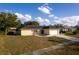 House exterior featuring a yellow facade, driveway, and landscaping at 5344 Lowell Ave, Spring Hill, FL 34609