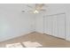 Bright bedroom with wood-look floors, ceiling fan, and ample closet space at 5344 Lowell Ave, Spring Hill, FL 34609