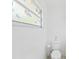 Simple bathroom with toilet and window featuring floral stained glass design at 5344 Lowell Ave, Spring Hill, FL 34609