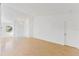 Bright living room with light wood floors and sliding glass door to patio at 5344 Lowell Ave, Spring Hill, FL 34609