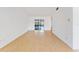 Bright and airy living room with light wood laminate floors and access to a patio at 5344 Lowell Ave, Spring Hill, FL 34609