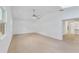 Main bedroom with light wood floors, vaulted ceiling and access to back yard at 5344 Lowell Ave, Spring Hill, FL 34609