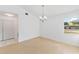 Simple dining room with light wood floors and chandelier at 5344 Lowell Ave, Spring Hill, FL 34609