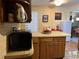 Kitchen with wood cabinets, microwave, and an island at 8471 52Nd N Ln, Pinellas Park, FL 33781