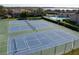 Community tennis courts with surrounding fence and nearby pool at 9209 Seminole Blvd # 75, Seminole, FL 33772
